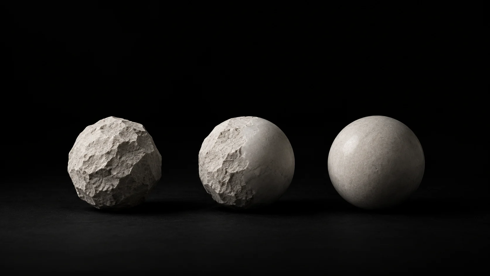 Three stone spheres show rough, partly worked, and smooth surfaces.