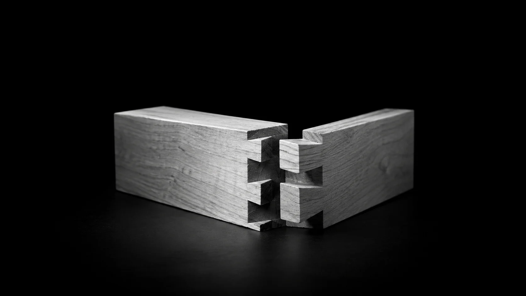 Two pieces of wood reveal the interlocking joints that hold them together.