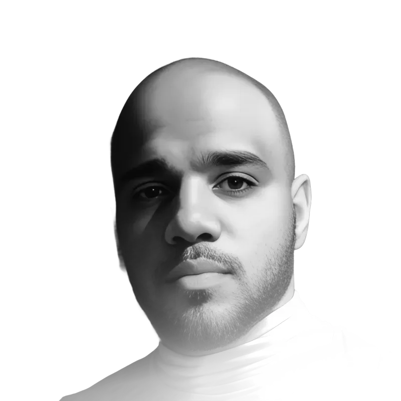 Black and white close-up portrait of André Givenchy in a white turtleneck against a black background.