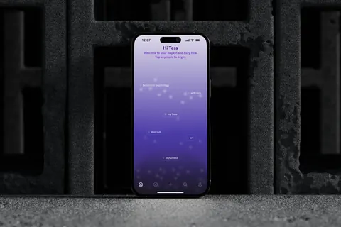 iPhone 16 displaying Napkin app "Home Screen" for topic exploration with topics like behavioral psychology, self-care, and joyfulness on a purple gradient background.