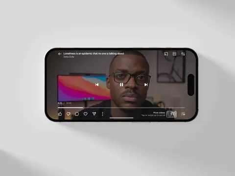 iPhone 16 displaying a paused video titled "Loneliness is an epidemic that no one is talking about" on the Gander app.