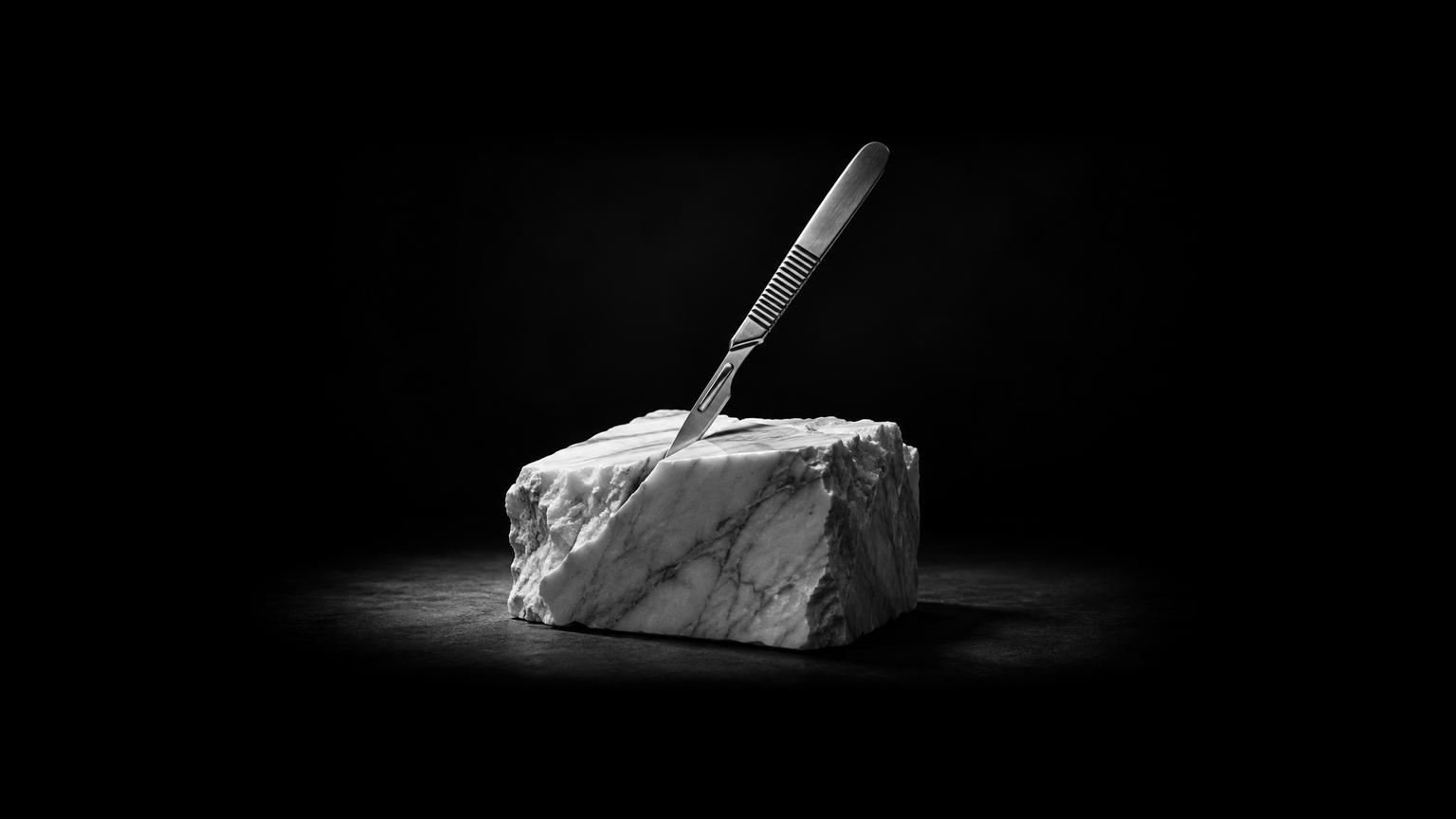 A scalpel poised in a block of white marble, lit dramatically against a covert backdrop.
